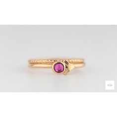 This beautiful set of elegant, handmade stacking rings feature a shimmering fuchsia (dark pink, magenta) colored cubic zirconia stone set in a gold filled bezel atop two gold-filled textured ring bands. The deep, sparkling color of the dark pink fuchsia pink cubic zirconia pairs perfectly with the bright gold lending a royal color combination and timeless beauty to the rings. US size 6, EU size 51.5: inside circumference is 2.04 inches, 51.9mm Pink Stackable Birthstone Promise Ring, Pink Gold Stackable Rings Fine Jewelry, Pink Gold Stackable Fine Jewelry Rings, Pink Gold Stackable Rings In Fine Jewelry Style, Pink Stackable Rings With Ethical Gemstones As Gift, Elegant Pink Sapphire Stackable Ring, Pink Ruby Stackable Jewelry, Fine Jewelry Gold Crystal Ring With Ruby, Pink Ring With Bezel Setting