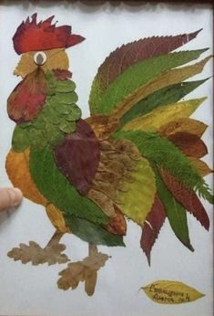 a drawing of a rooster made out of leaves