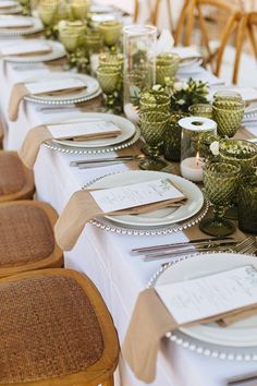 the table is set with place settings for dinner