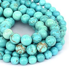 turquoise beads with brown speckles are stacked on top of each other