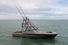 a fishing boat in the water with two rods attached to it's hulls