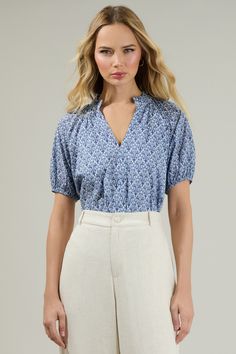 The Lena Floral Split Neck Top is an effortless way to show everyone you know style! Puff shorts sleeves enhance this cute top with a split neckline and ruffles around the neck. You can tuck it in or as is with white pants and some heels or loafers to go along. - V-neck- Ruffle trim- Short sleeves- Lined- Color: Blue whiteSize + Fit - Model is 5'8" and wearing size XS- Measurements taken from size S - Chest: 21"- Length: 24 1/2" Fabric Self: 100% Cotton, Lining: 97% Polyester 3% Spandex Style Nu Summer V-neck Puff Sleeve Top For Daywear, Chic Puff Sleeve Top With Relaxed Fit, Chic Relaxed Fit Puff Sleeve Top With Short Sleeves, Blue Short Sleeve Blouse For Daywear, Summer Puff Sleeve Top With Short Sleeves, Summer Puff Sleeve Top With Short Sleeves For Daywear, Summer Puff Sleeve Top For Daywear, Summer Short Sleeve Puff Top, Short Sleeve Puff Top For Summer Daywear