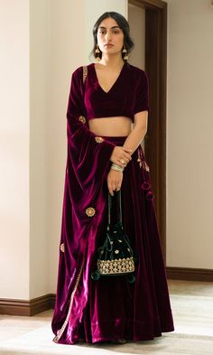 This 2 pc set includes Silk velvet blouse and lehenga. Pockets and shawl hand embroidered with sequins, dabka, nakshi and zari. COLOR: Deep orchid FABRIC USED: Silk velvet      CARE: Dry Clean Only  SKU: DRZBARE005   blouse length 15lehenga length 42 भारतीय दुल्हन संबंधी, Velvet Blouse Design, डिजाइनर कपड़े, Velvet Lehenga, Indian Outfits Lehenga, Wedding Lehenga Designs, Lehenga Designs Simple, Velvet Dress Designs, Indian Dresses Traditional