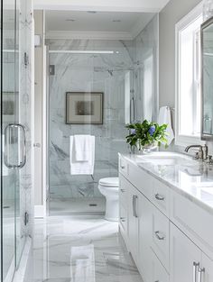 a white bathroom with marble floors and walls