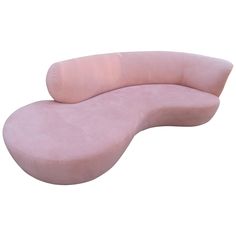 a pink couch sitting on top of a white floor