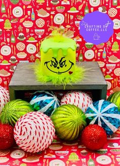 a table topped with lots of christmas balls and candy canes on top of it