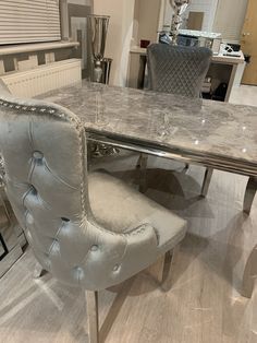 a marble dining table and chairs in a room