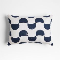 a white and blue pillow with black circles on it