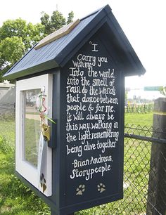 a small black and white dog house with writing on it