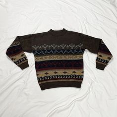 Vintage 1980s long sleeve brown knit sweater. In good vintage condition. Note: I try to match colors as much as possible to pictures but there is a possibility it won't be an exact match. Unless the color is completely incorrect I am unable to offer refunds for this reason. Size: men's medium Brand is The Men's Store at Sears Measurements (taken on garment laid flat): Armpit to armpit: 23" Waist: 40" Shoulder to shoulder: 22" Armpit to hem: 17" Length (top of neck to bottom hem): 25.5" Fabric: 100% acrylic Retro Brown Sweater For Fall, Casual Brown Fair Isle Pattern Sweater, Retro Brown Crew Neck Sweater, Vintage Brown Long Sleeve Sweater, Vintage Long Sleeve Brown Sweater, Brown Knitted Crew Neck Sweater, Cozy Brown Crew Neck Sweater, Brown Fair Isle Sweater For Fall, Vintage Crew Neck Sweater For Fall