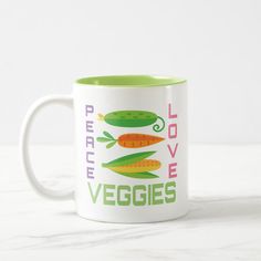 a white and green coffee mug with carrots on the side that says perfect veggies