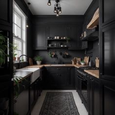 a kitchen with black cabinets and an area rug