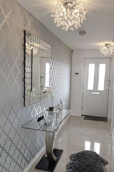 a bathroom with a mirror, sink and chandelier on the wall in it