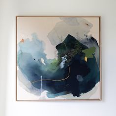 an abstract painting hangs on the wall