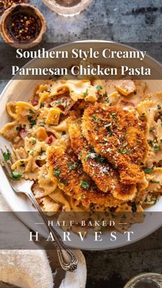 southern style creamy parmesan chicken pasta in a white bowl with a fork on the side