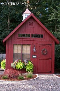 a red shed with flowers in the window