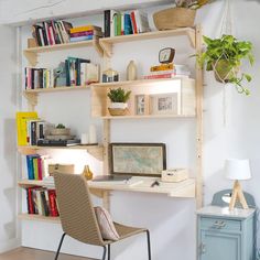 a chair and desk in front of a bookshelf