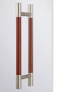 an image of a door handle that is red and stainless steel with brown leather trim