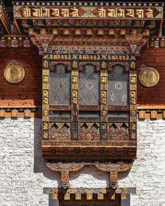 an intricately decorated window on the side of a building