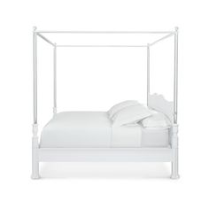 a white bed with four posts and pillows on top of it, against a white background