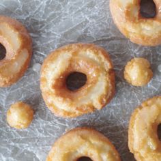 several glazed donuts sitting on wax paper