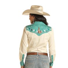 Style number LWN2S03440 Cream abutton down shirt Contrast teal trim and yokes Embroidered howling coyote and stars on front & back yoke Cross stitching under emroidered graphics on front and back yoke White piping around yokes Western smile pockets with teal piping 100% cotton Weatern Shirt Prints, Loved By A Cowboy Shirt, Cinch Western Women Shirts, Modern Western Shirts, Western Shirts For Women, Howling Coyote, Homesteading Animals, Teal Trim, Western Top