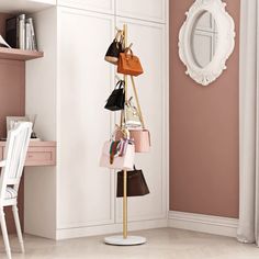 there is a coat rack with purses on it and a mirror in the corner