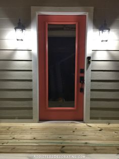 a red front door with two lights above it