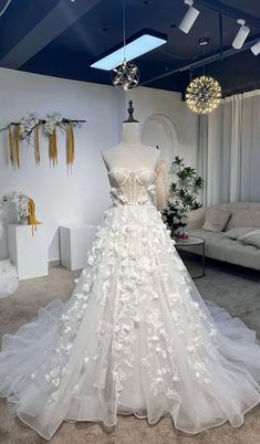 a white wedding dress on display in a room