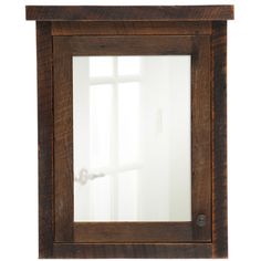 a wooden frame mirror hanging on the wall