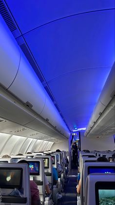 the inside of an airplane with blue lighting