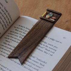 an open book with a wooden cross on it