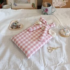 a white bed topped with lots of items on top of it