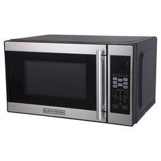 a microwave oven with the door open and its electronic controls on it's side