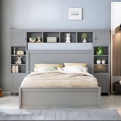 a bedroom with a bed, bookcases and other items on the shelves in front of it