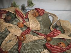 some burlap bags with wooden buttons and ribbon tied around them on a table