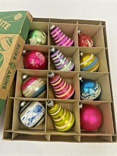 an open box filled with assorted christmas ornaments