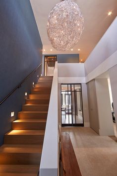 a large chandelier hanging from the ceiling above a set of stairs