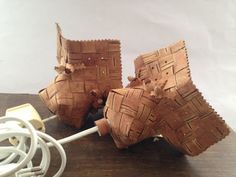 two pieces of wood sitting on top of a table next to an apple charger