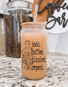 a coffee mug sitting on top of a counter next to a pile of coffee beans