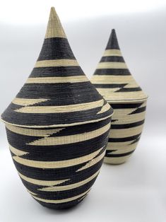 two black and white vases sitting next to each other