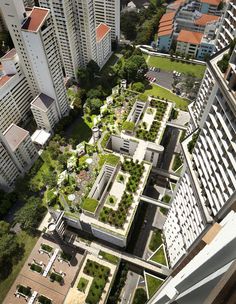 an aerial view of a city with lots of tall buildings and green roof gardens on the rooftops