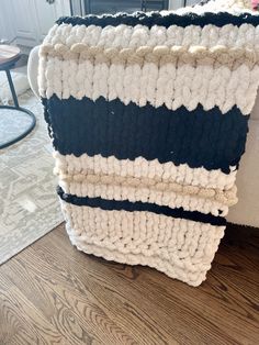 a pile of blankets sitting on top of a wooden floor