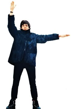 a man standing on top of a skateboard in front of a white background with his arms outstretched