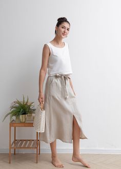 "★★FEATURES 100% Linen Front two pockets Elastic waist skirt Belt skirt Pleated waist details Front split skirt Casual skirt Perfect for Summer, Spring, Autumn ★★ Model Size Height approx 162 cm (5′ 4″) Bust 84 cm (33\") Waist 66 cm (26\") She wears size XS. ★★ Bespoke Order Service If you Request other color Request the length Your height is not between 155 cm- 172 cm Your weight is over 75 kg I can do it for you, It will need some extra fee depending on on your need. Contact with me for more d Casual Tie Waist Mini Wrap Skirt, Casual High-waisted Skirt With Tie Waist, Casual High Waist Skirt With Tie Waist, Casual High Waist Skirt With Tie, Casual White Skirt With Side Pockets, Casual Mini Wrap Skirt, Casual Lined Midi Wrap Skirt, Casual Midi Wrap Skirt With Lining, Casual White Midi Wrap Skirt