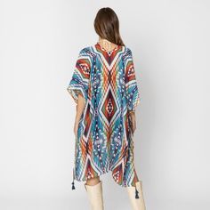 Aztec Print Kimono with Tassel Details – A Bold and Beautiful Statement Piece Add a pop of color and style to your wardrobe with this stunning Aztec Print Kimono with Tassel Details. Featuring a vibrant and eye-catching blend of brown, turquoise, orange, and white, this kimono is the perfect way to make a statement while staying comfortable and chic. Whether you’re layering it over a casual outfit or dressing it up for a special occasion, this kimono adds a touch of elegance and bohemian flair t Multicolor Spring Kaftan With Back Tassel Tie-up, Bohemian Multicolor Tassel Cover-up, Multicolor Kaftan With Back Tassel Tie-up For Summer, Multicolor Vacation Kaftan With Tassels, Spring Multicolor Kaftan With Tassels, Multicolor Tasseled Kaftan For Vacation, Multicolor Tassel Kaftan For Vacation, Bohemian Multicolor Kaftan With Back Tassel Tie-up, Casual Multicolor Boho Print Cover-up