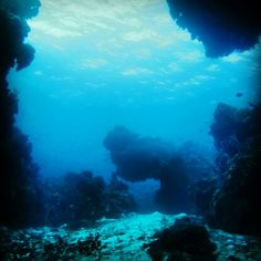 an underwater view of the ocean with rocks and water