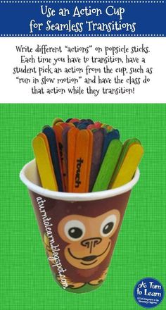 a cup filled with pencils sitting on top of a green table next to an advertisement for