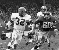 two football players running on the field during a game