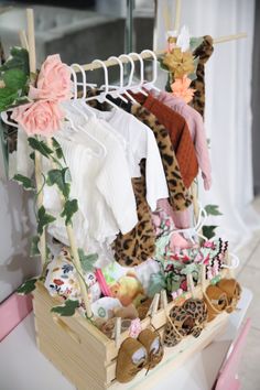 a wooden box filled with lots of clothes and other items on top of a table